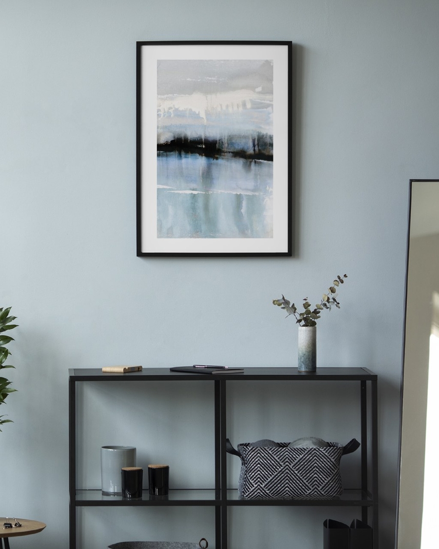 Meltwater Horizon poster in a slim black frame on a pale blue wall above a black metal console shelf