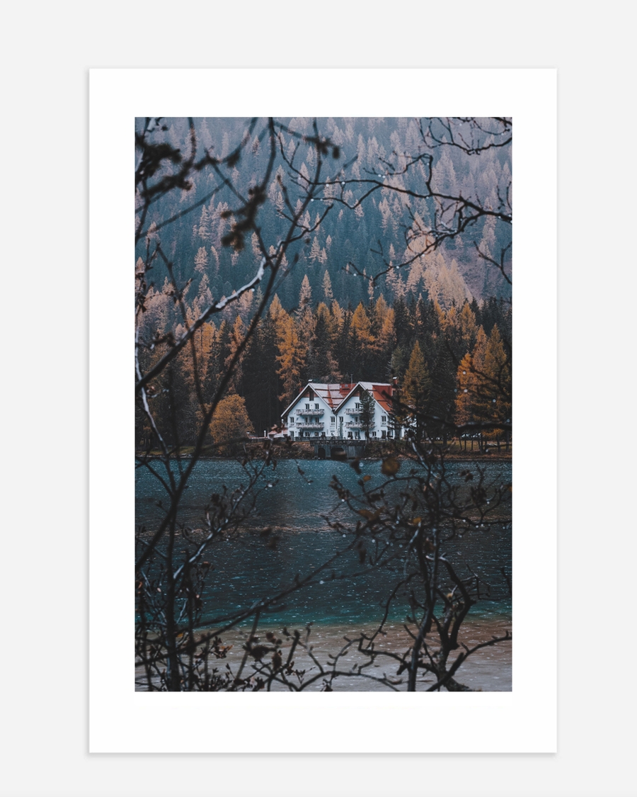 A poster of a White house by lake surrounded by autumn forest