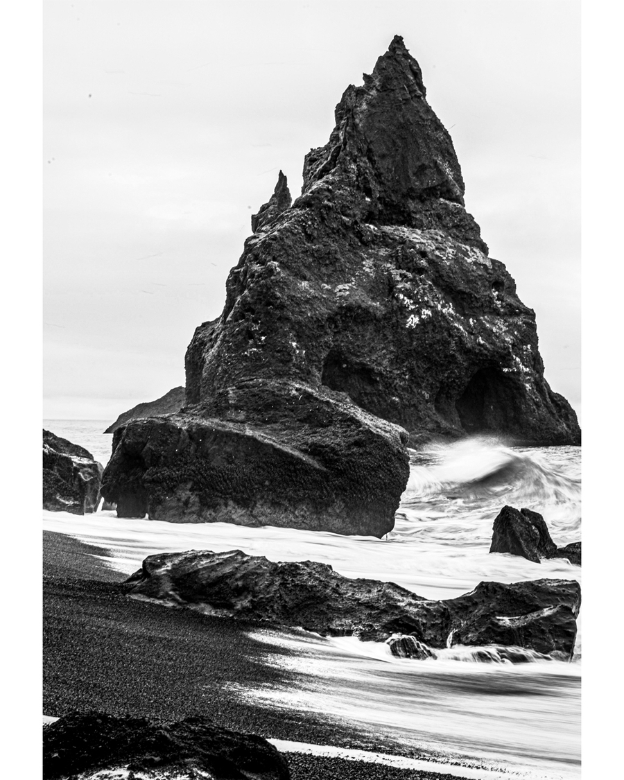Black and white photo of rugged sea rock