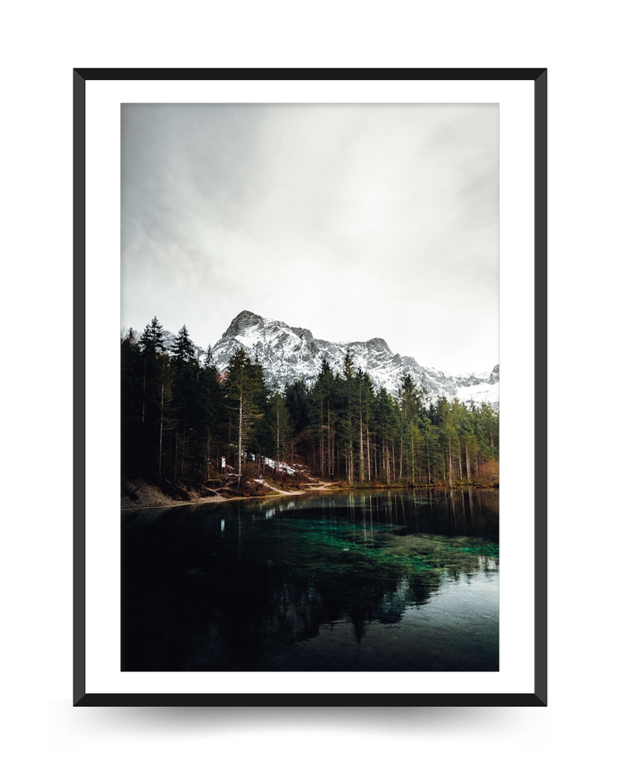 A poster of a Mountain lake with forest and snowy peaks reflected