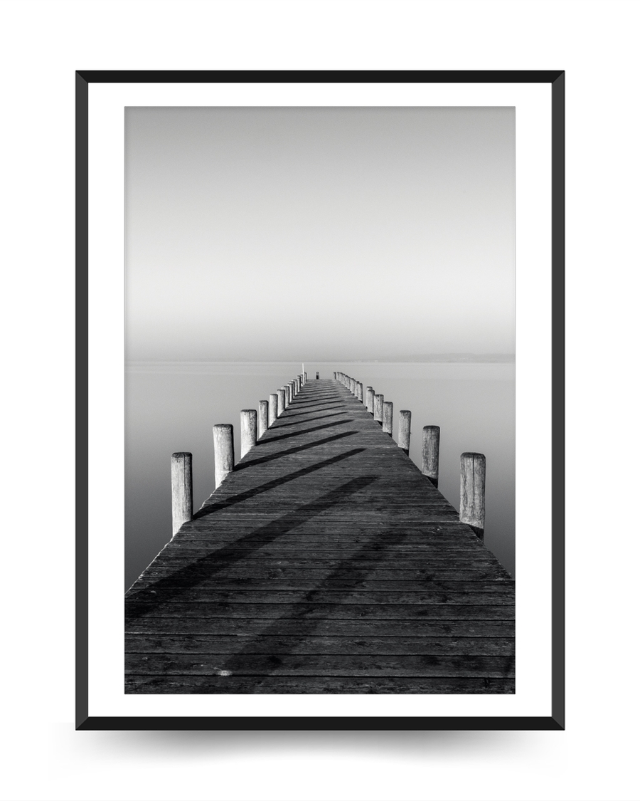 A poster of a Symmetrical wooden pier leading into calm water