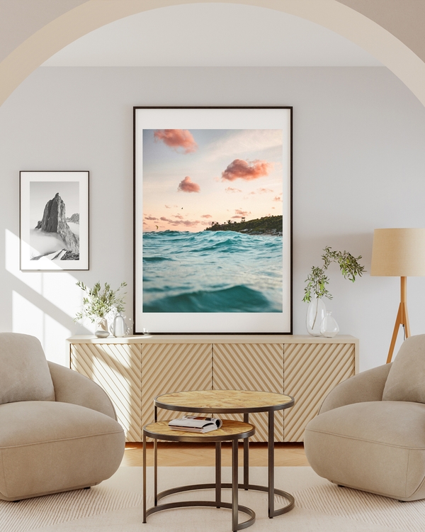 Poster of a clear sky with blue water hanged on a white wall over a light brown table