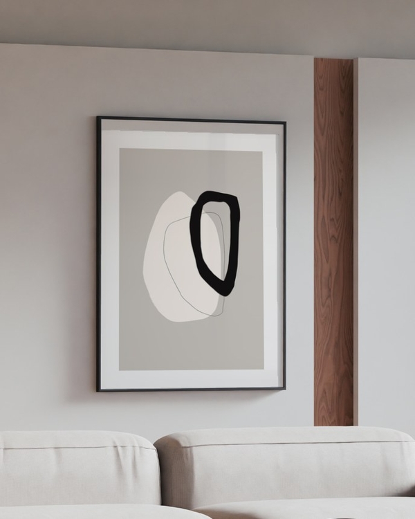 Loop and Form poster in a slim black frame above a cream modular sofa in a modern living room