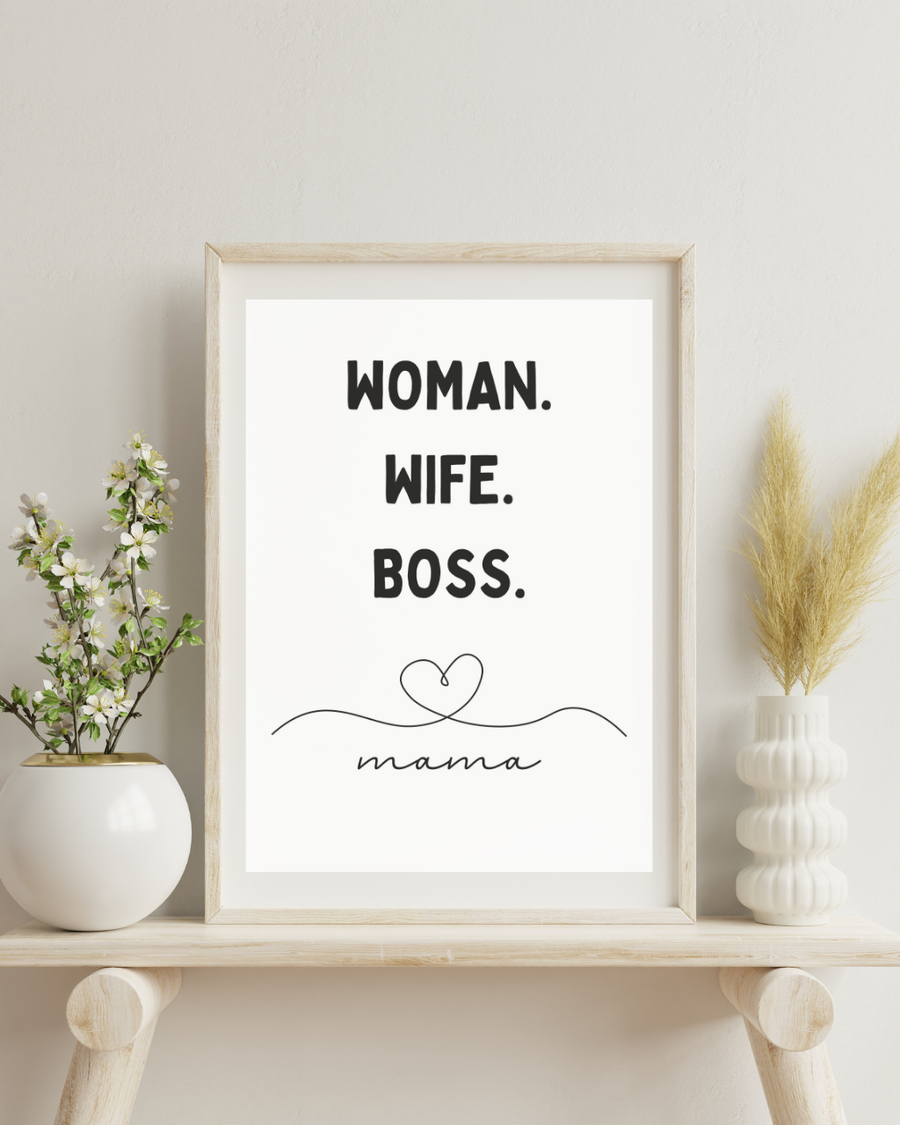 A poster of texts woman, wife, boss, mamma placed between two vases