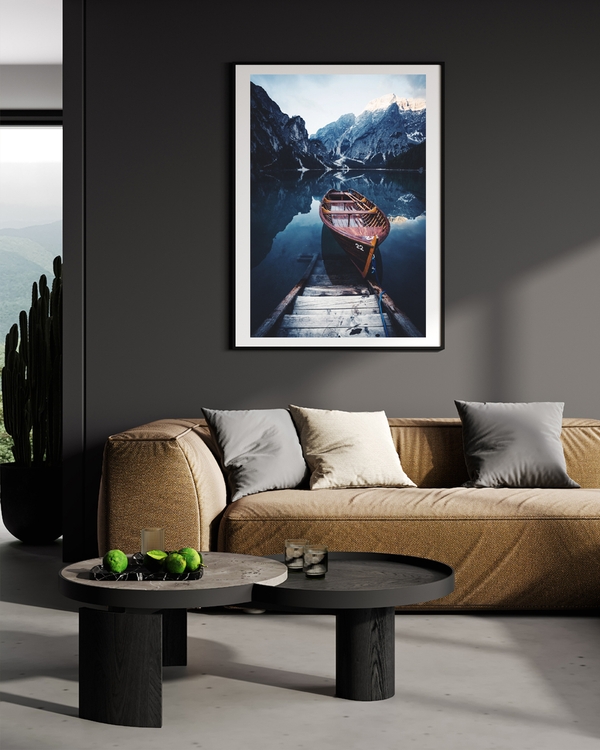 A poster of a Wooden boat moored on calm alpine lake with mountains