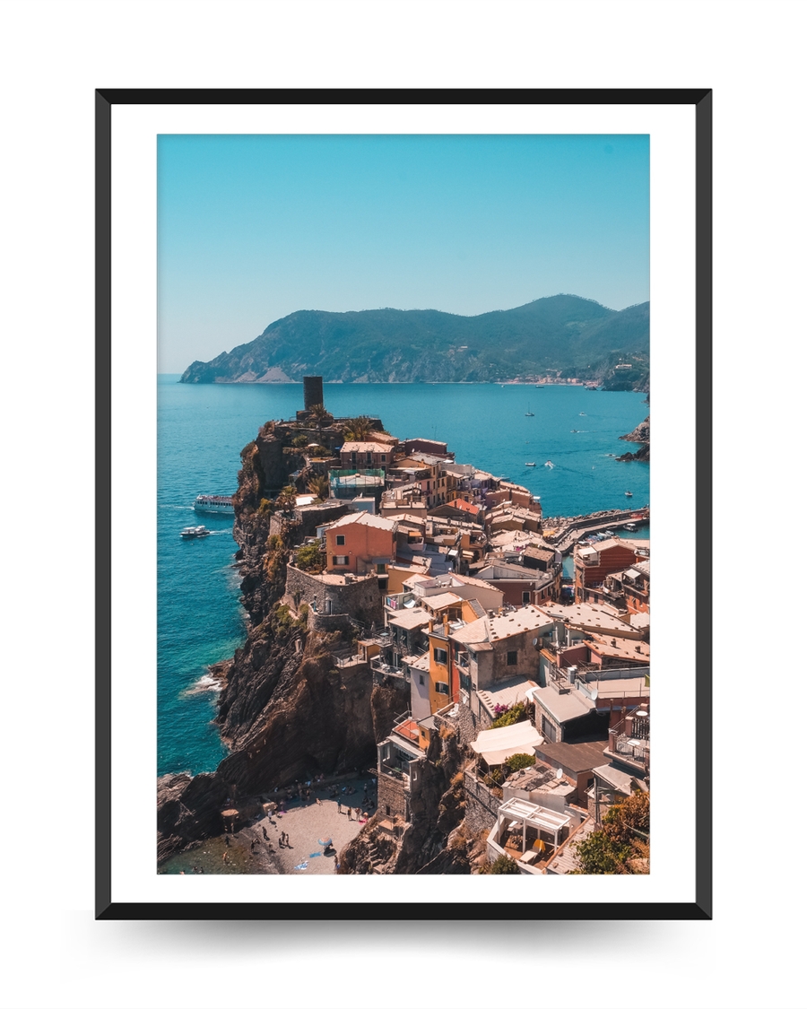 A poster fo a Coastal village on cliffs above turquoise sea