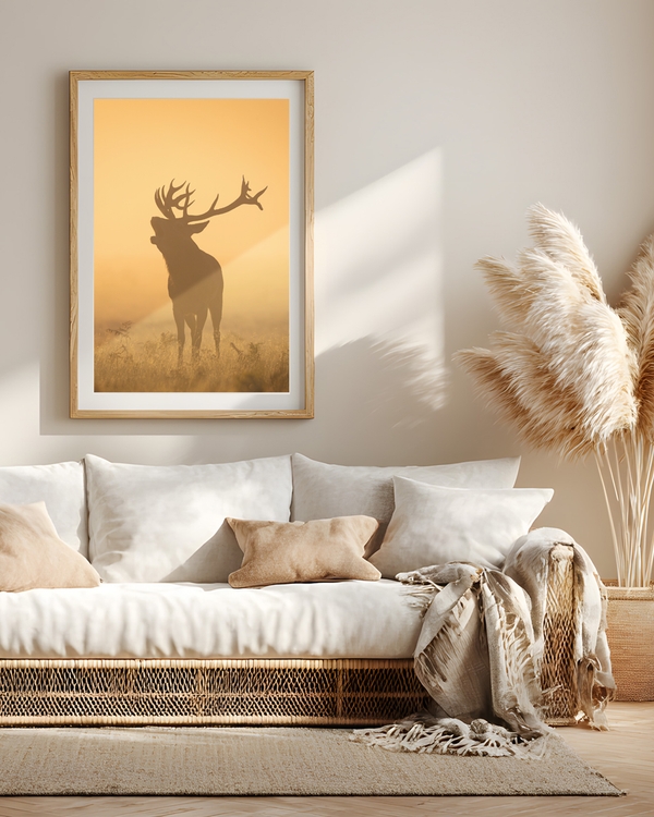 A poster of a Silhouetted deer standing in golden misty field