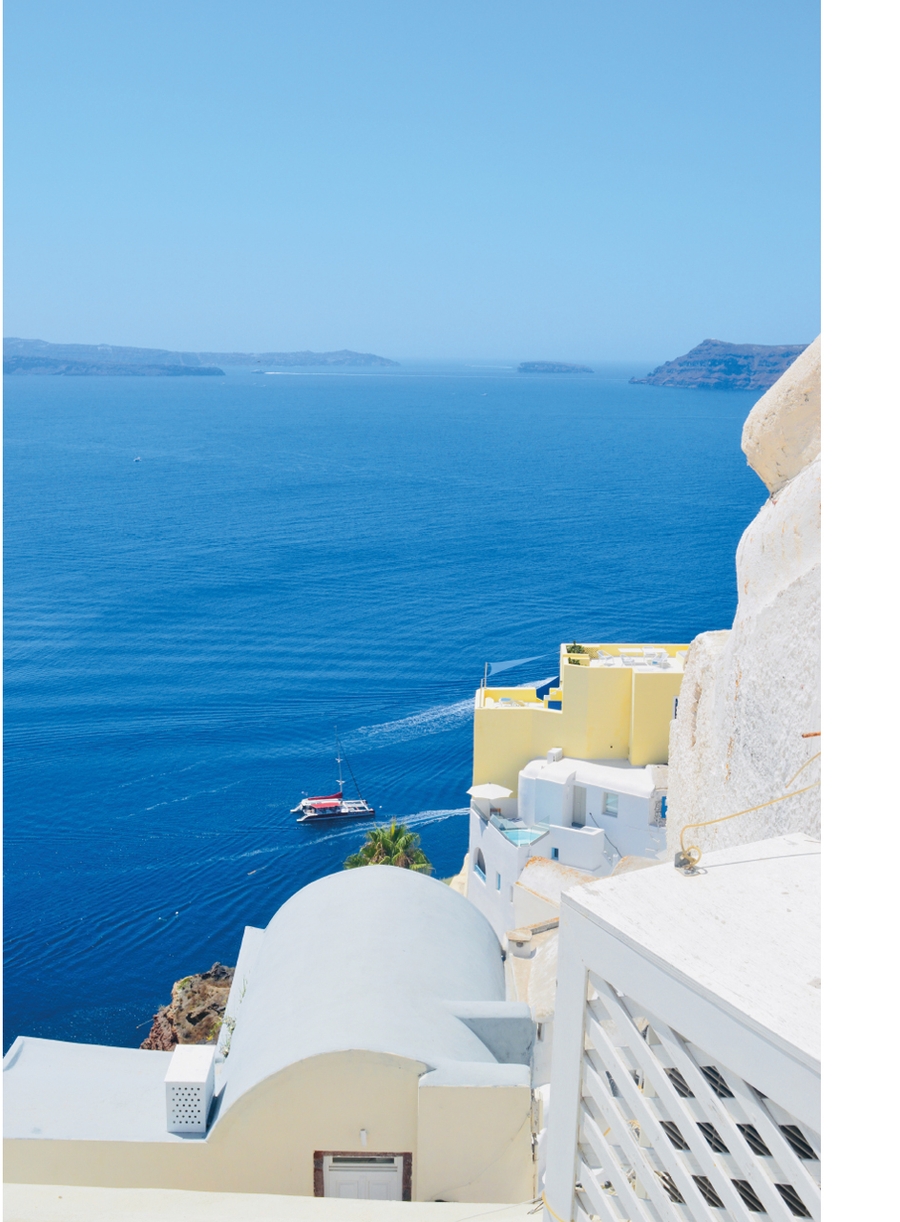 White coastal buildings overlooking deep blue sea