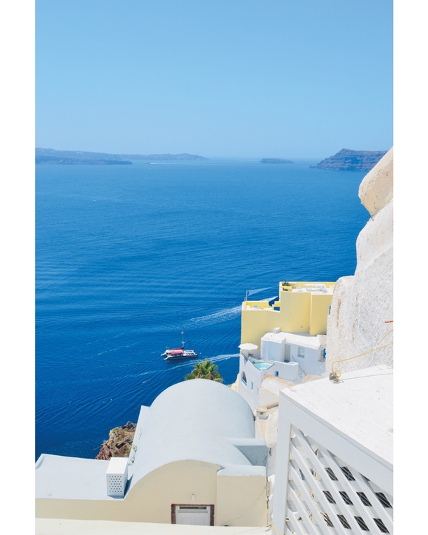 White coastal buildings overlooking deep blue sea