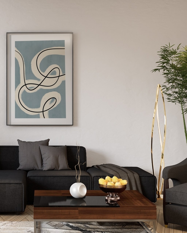Ribbon and Ink poster in a slim black frame above a dark grey sofa in a modern living room