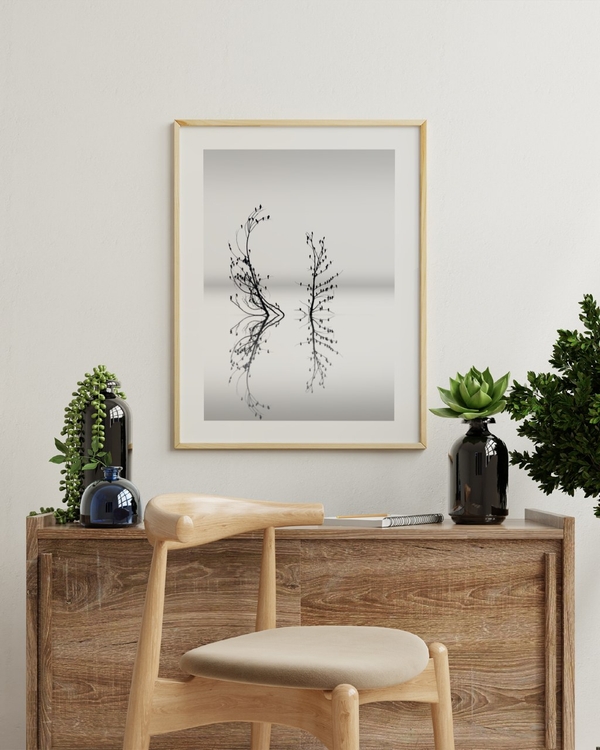 Birds on Still Water poster in a slim light wood frame above a rustic wooden sideboard