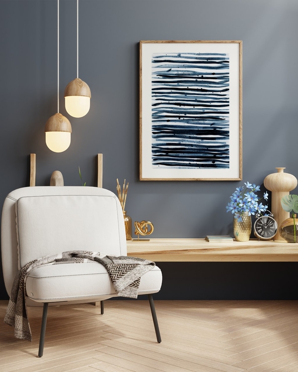Indigo Stripes poster in a light oak frame above a wooden console in a dark blue-grey living room