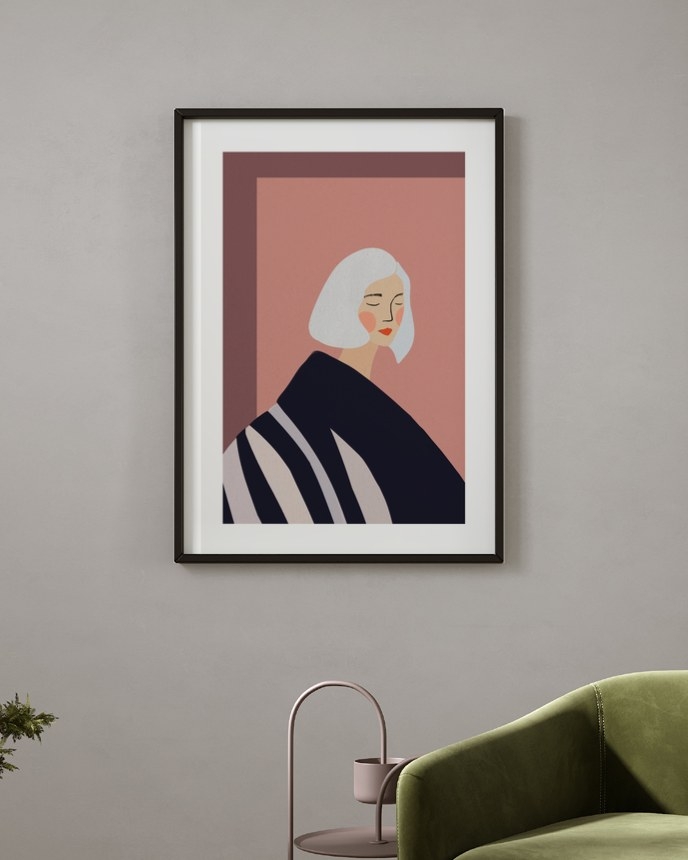 Blush Hour Portrait poster in a slim black frame on a grey wall above a green velvet armchair