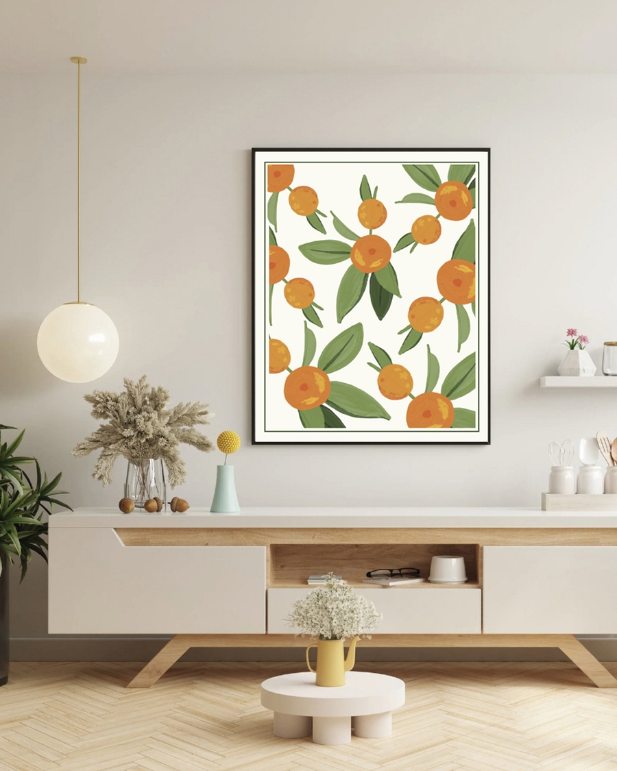 A poster of oranges with green leaves hanged over a table