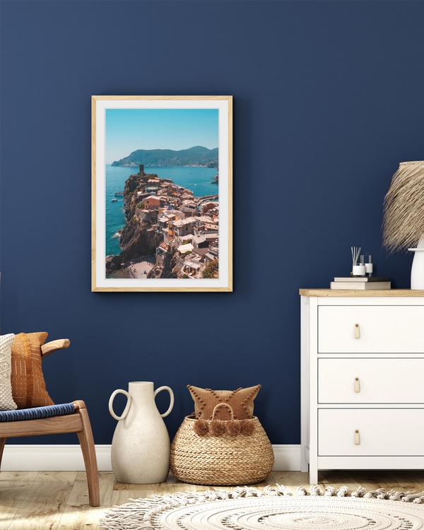 A poster fo a Coastal village on cliffs above turquoise sea