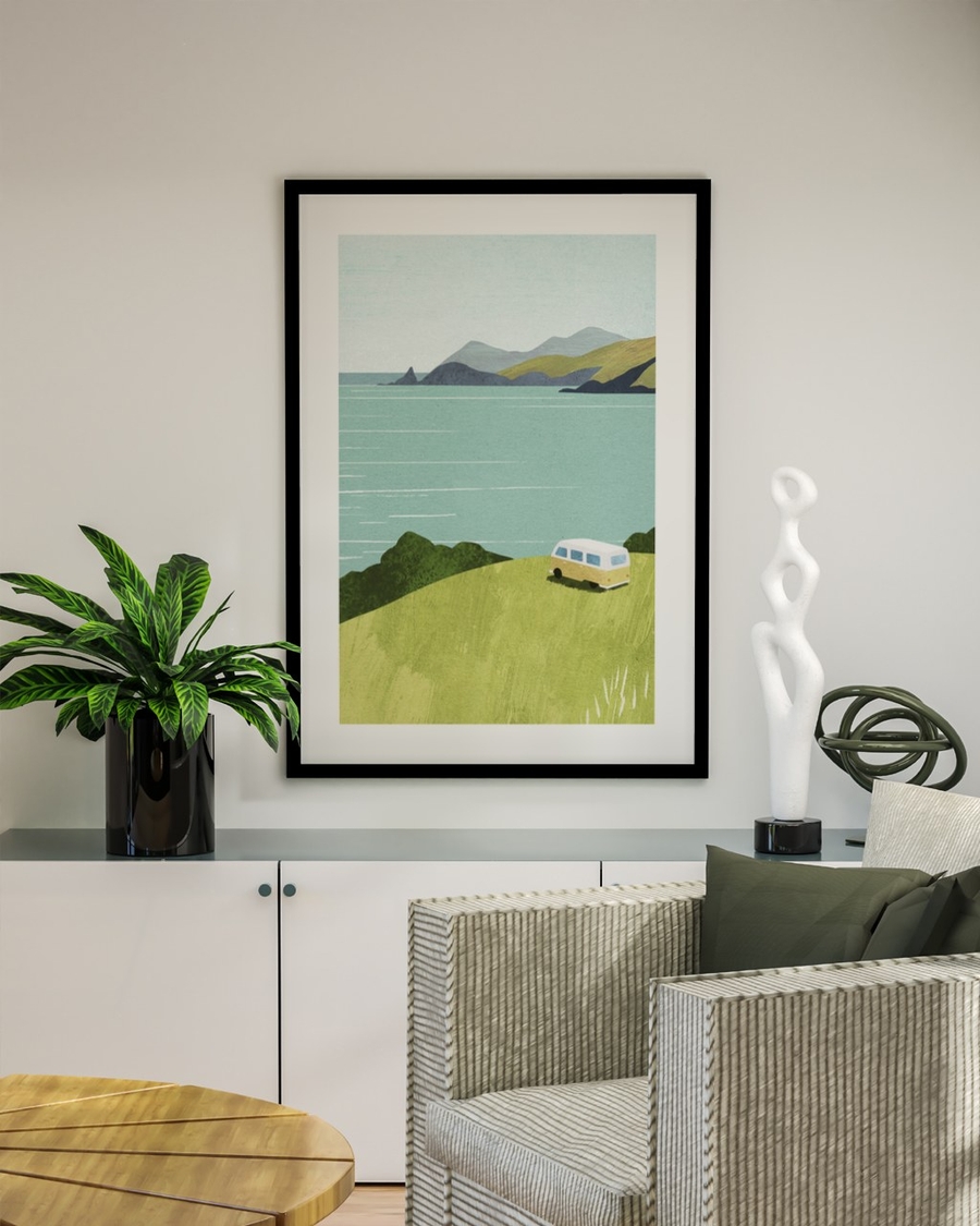 Camper by the Bay poster in a black frame above a white sideboard in a bright living room