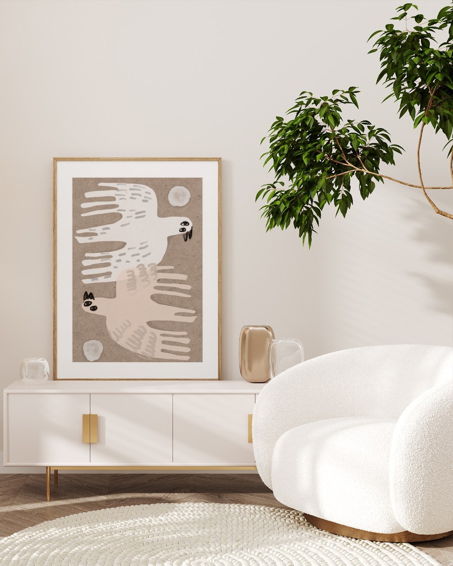 Pair in Flight poster in a light oak frame leaning on a white sideboard in a bright living room