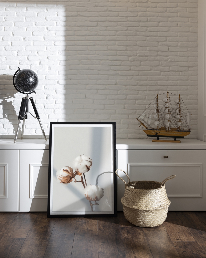 A poster of a Cotton branches with soft light on neutral background