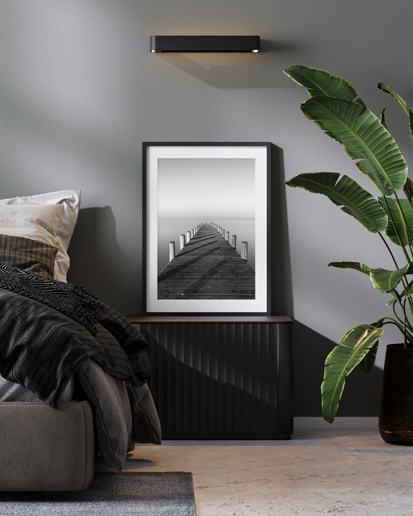 A poster of a Symmetrical wooden pier leading into calm water