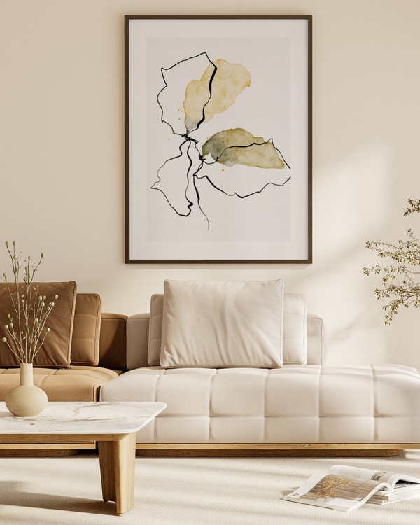 Ink and Ochre Bloom poster in a dark slim frame above a cream sofa in a warm neutral living room