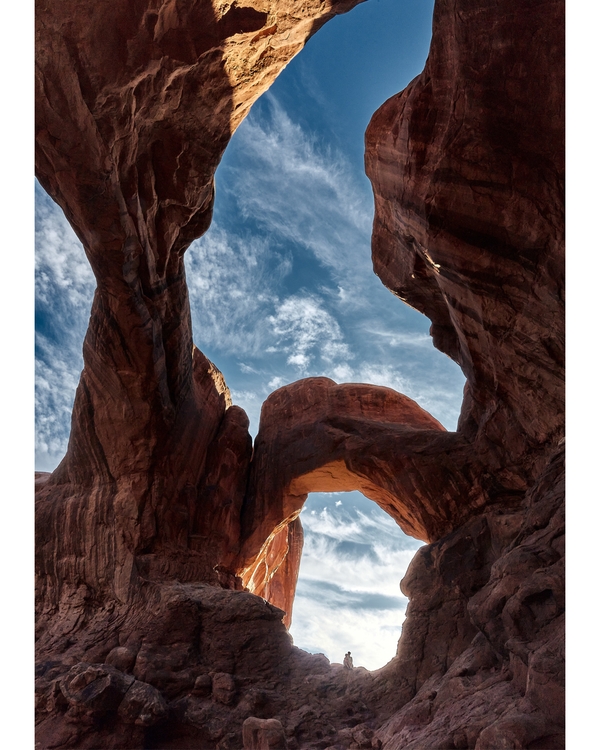 Towering red rock arches with blue sky background