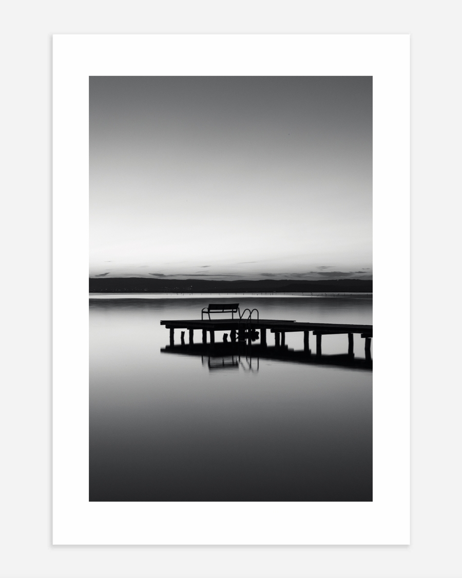 A poster of a Pier reflected in calm water at dusk