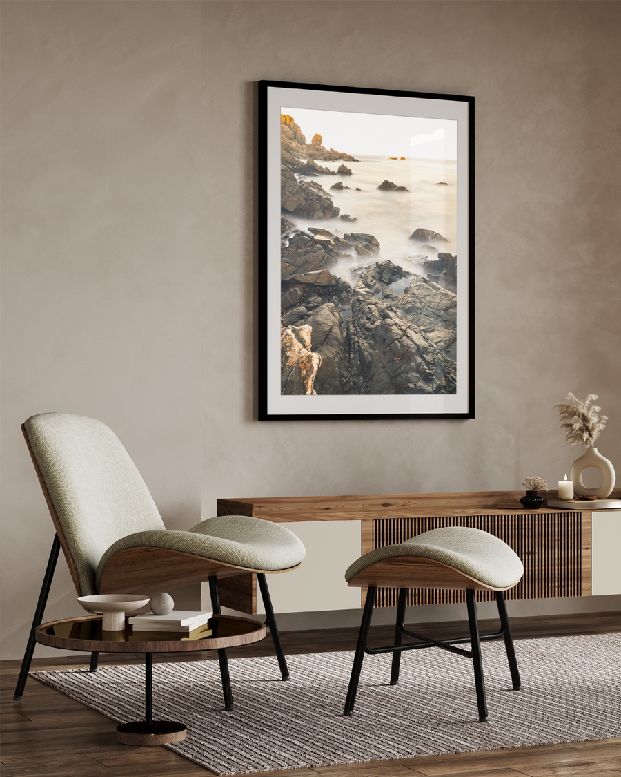 A poster of a Rocky coastline with misty water and soft light