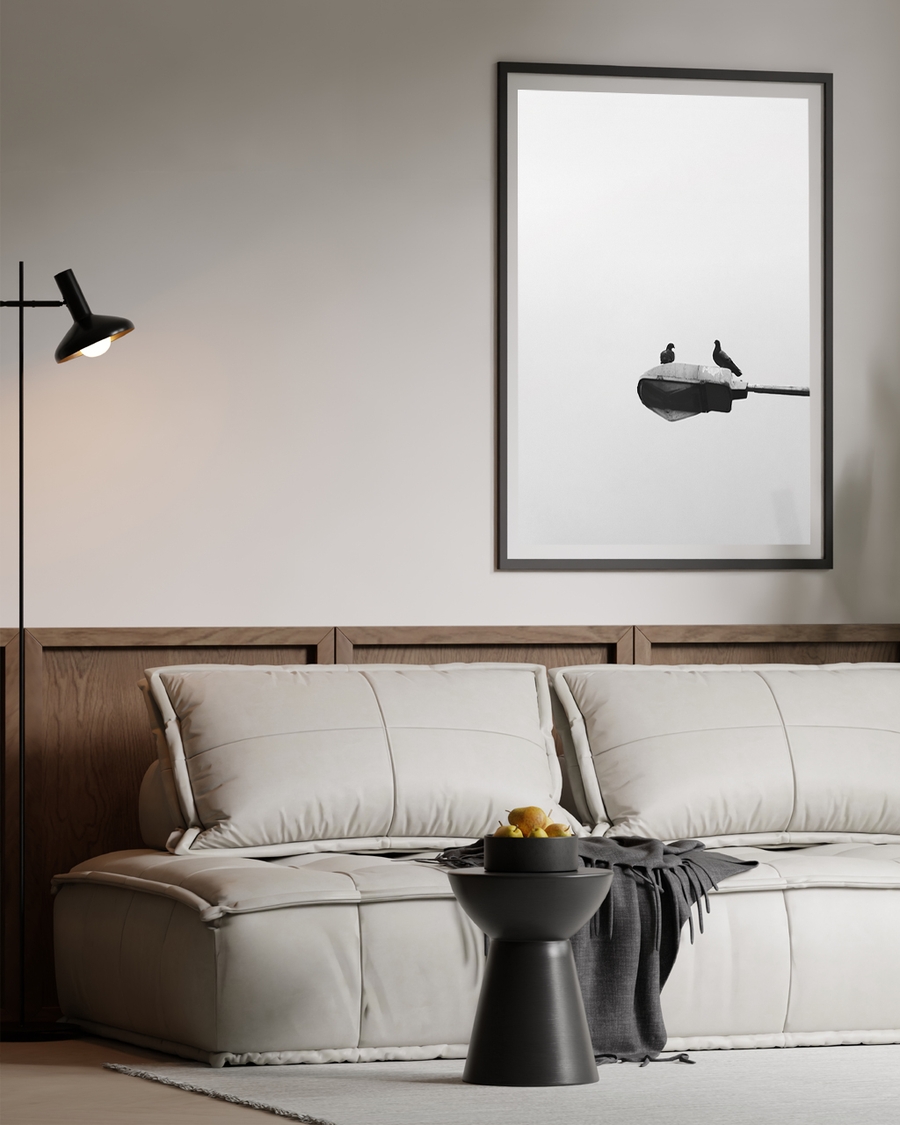 A poster of a two birds perched on streetlamp against empty sky