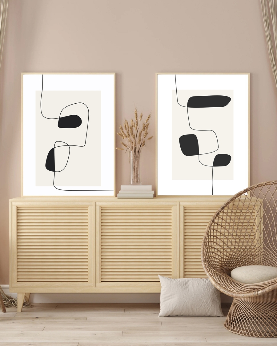 Two posters of wiggly lines hanged on the floor above a table