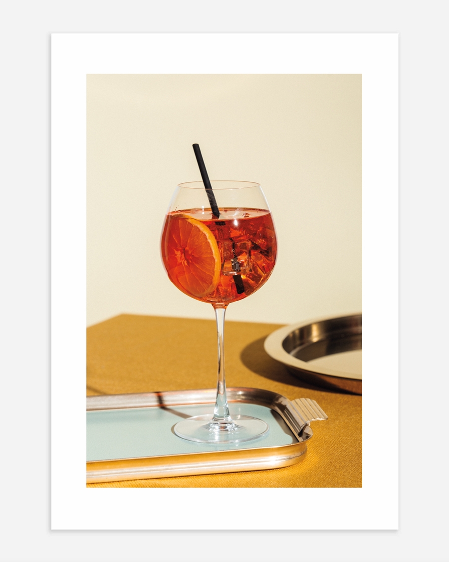 A poster of a Orange cocktail in wine glass on tray
