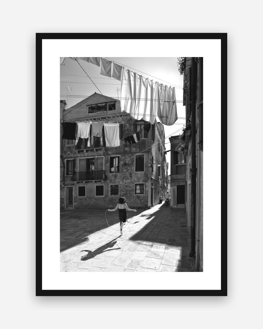 Skipping Through Sunlight poster with a white border in a black frame