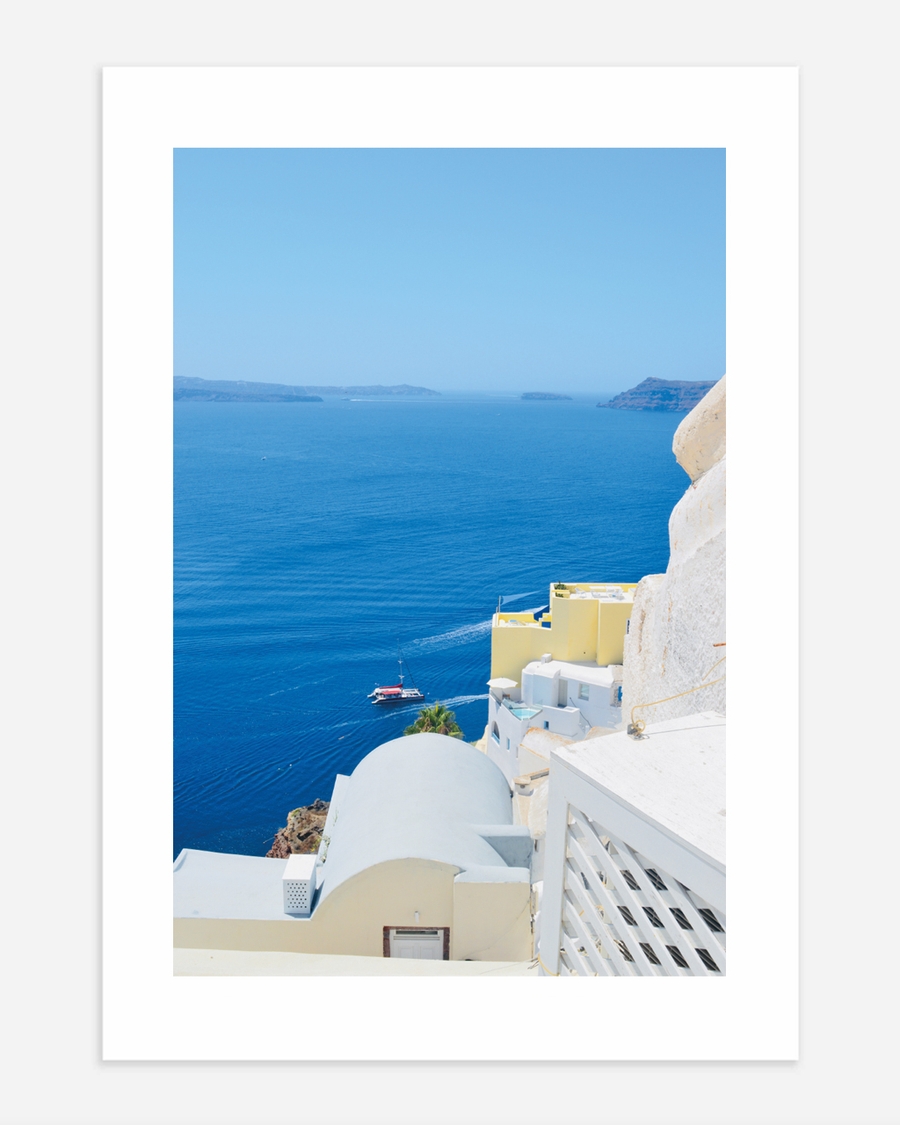 A poster of a White coastal buildings overlooking deep blue sea