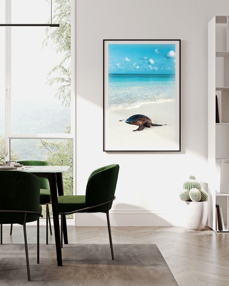 A poster of a Sea turtle resting on sandy beach by ocean