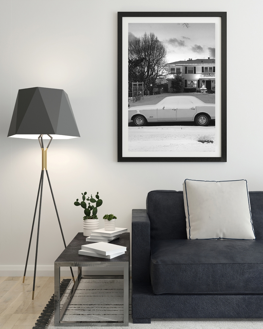 A poster of a classic car covered in snow in front house