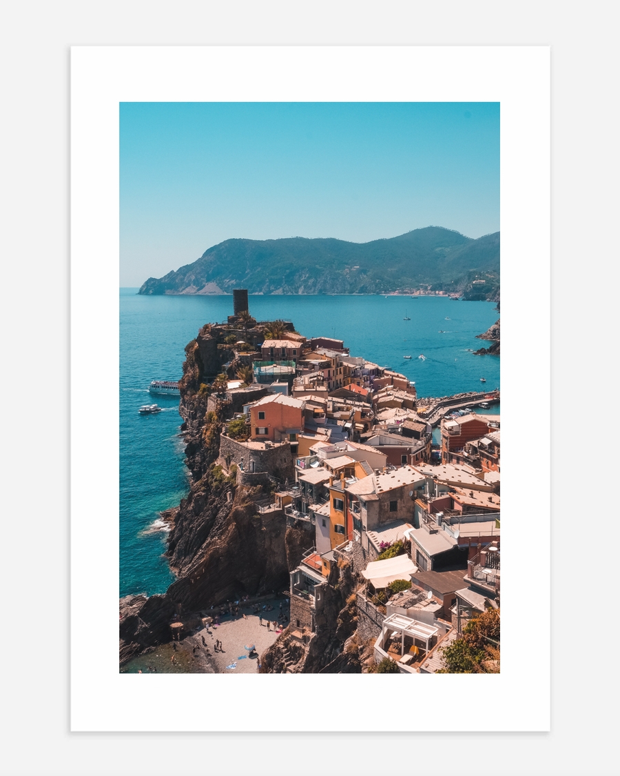 A poster fo a Coastal village on cliffs above turquoise sea
