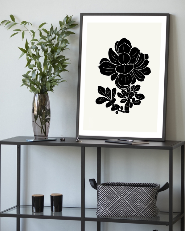 A poster of a black floral silhouette on soft ivory background.