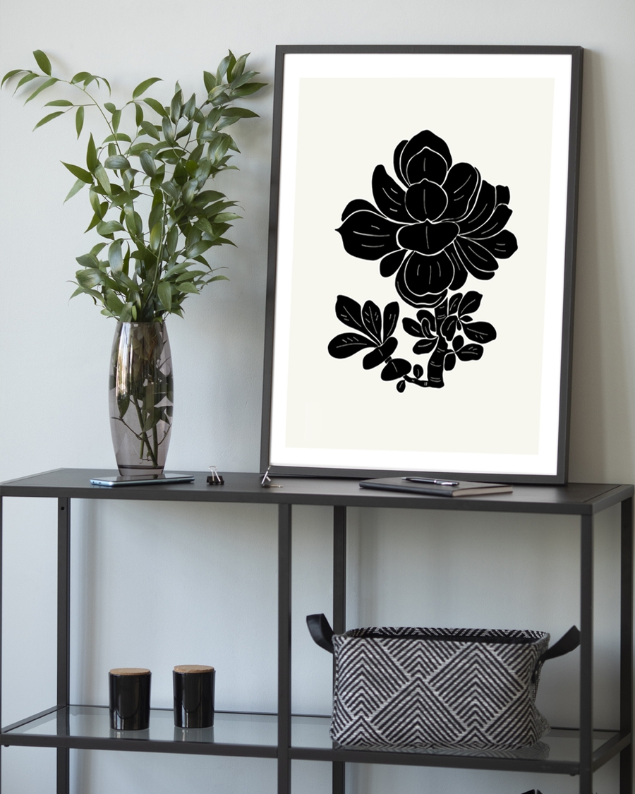 A poster of a black floral silhouette on soft ivory background.