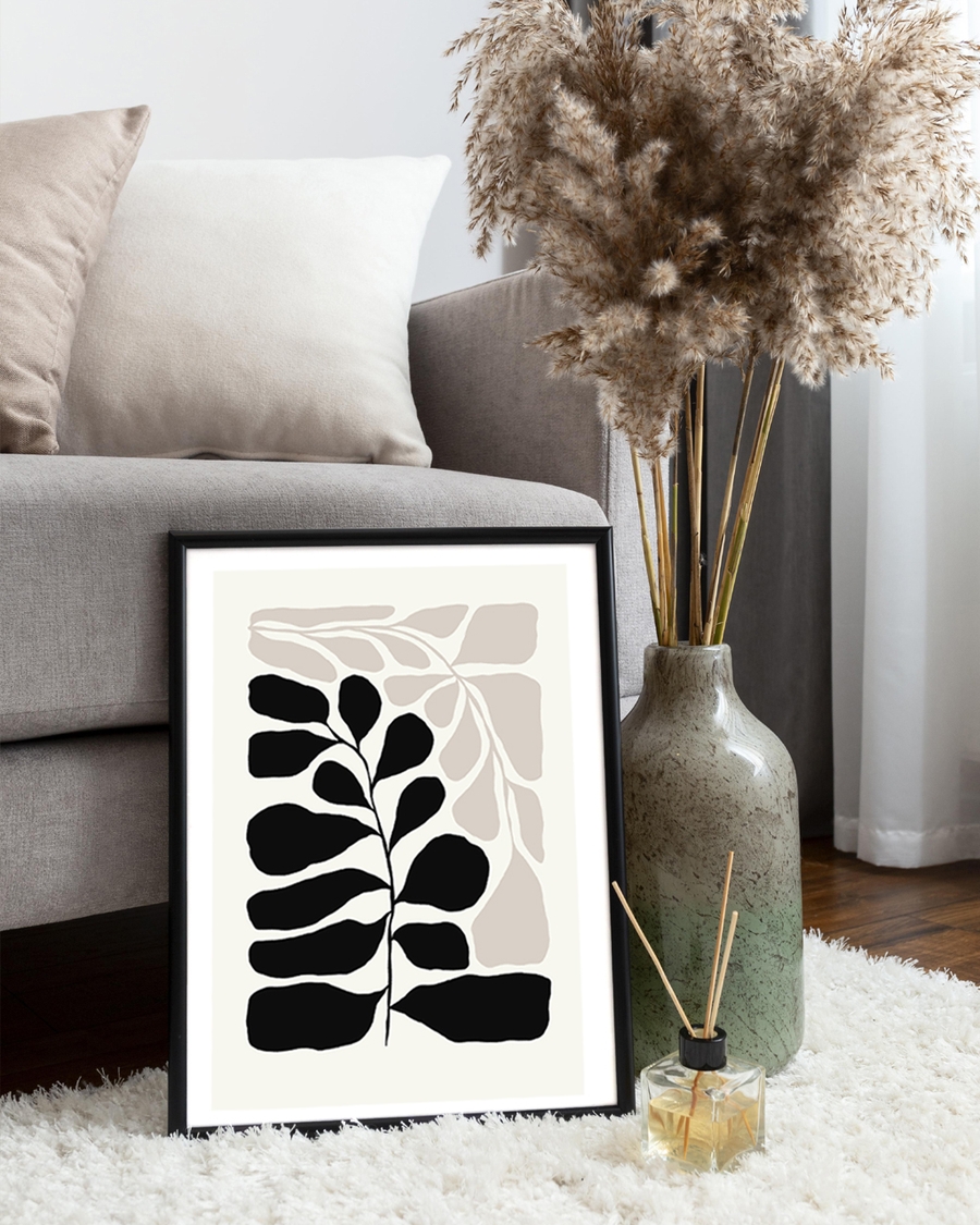 A poster of a black and beige leaf shapes on light background