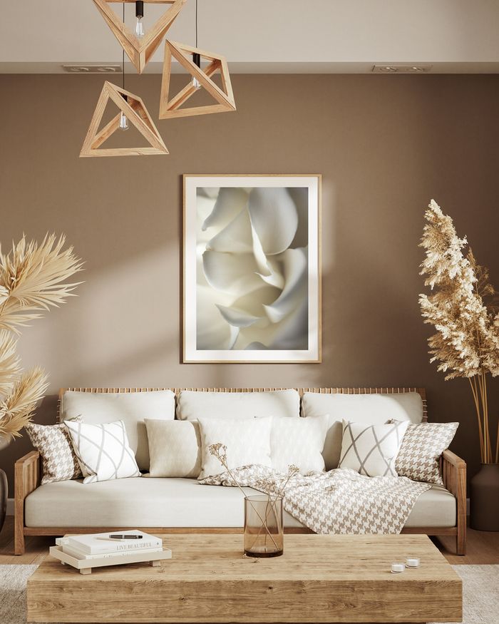 A framed poster of a white rose petals hanged on a light brown wall