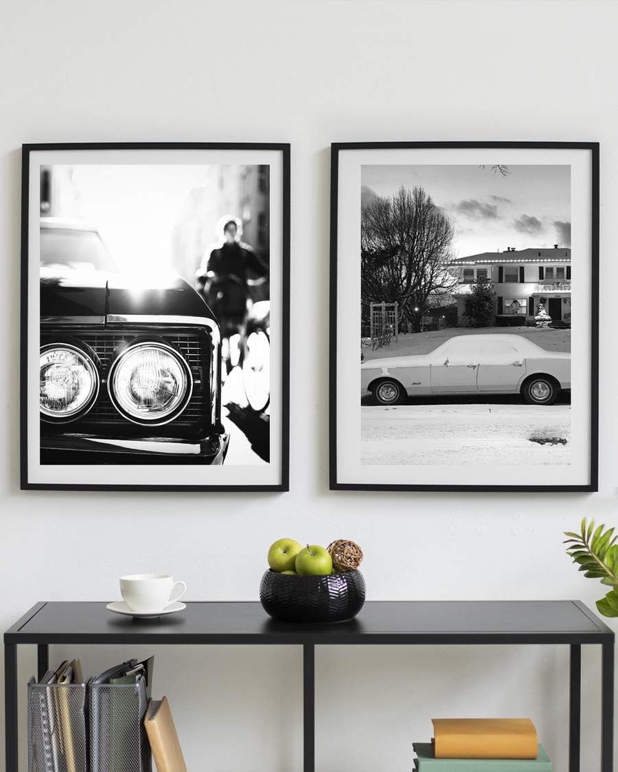 A poster of a Close-up of classic car headlights with blurred city background.