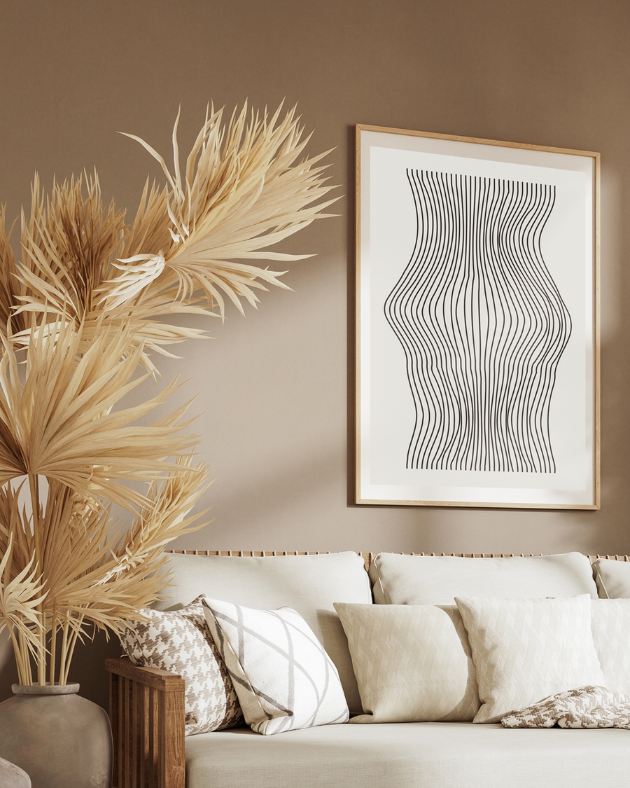 Poster of black lines on a beige background hanged on a light brown wall over a furniture
