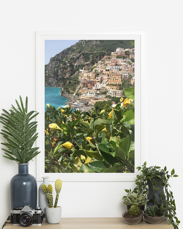 A poster of a Colorful hillside village by turquoise sea and greenery