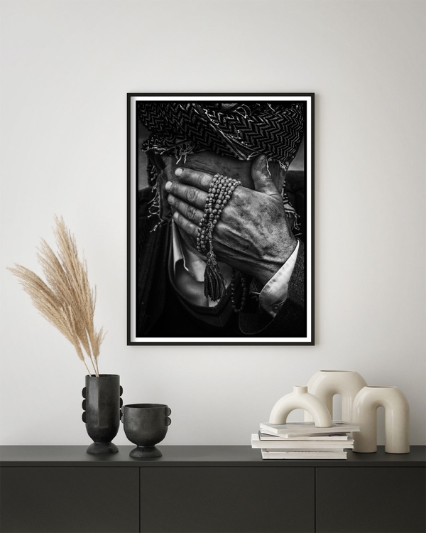 a poster of an elderly man that has been hung on a green wall