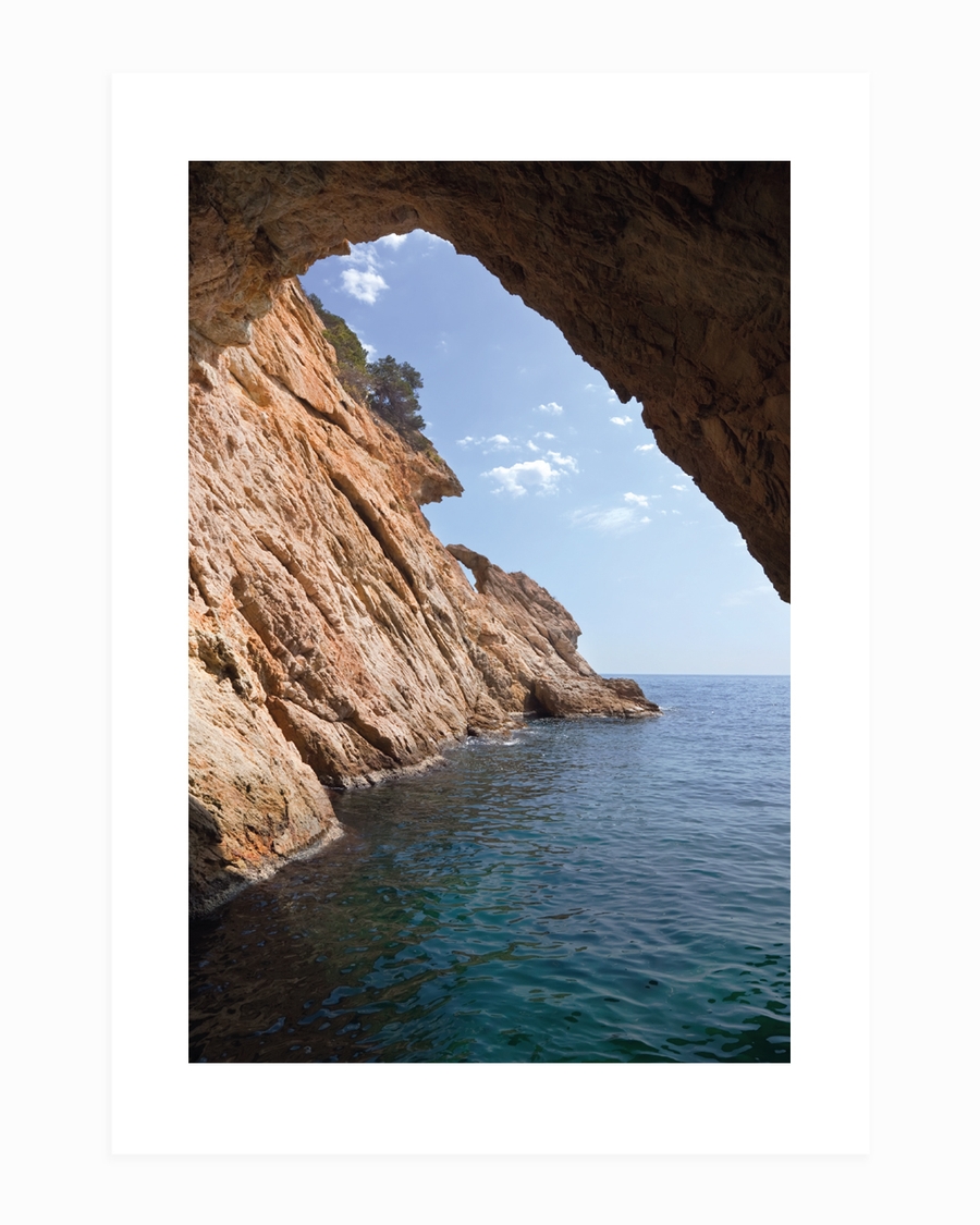A poster of a Rocky coastal cave opening toward calm blue sea