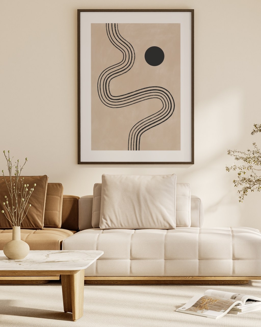 Winding Ink Path poster in a dark slim frame above a cream sofa in a warm neutral living room