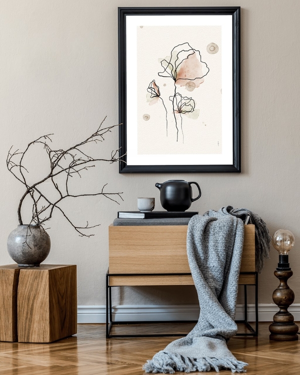 Ink Line Blossoms poster in a black frame above a wooden sideboard in a calm neutral hallway