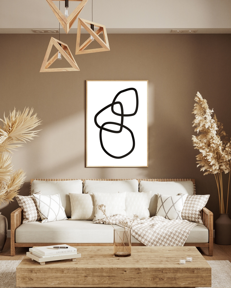 A poster of three random black rings hanged on a brown wall