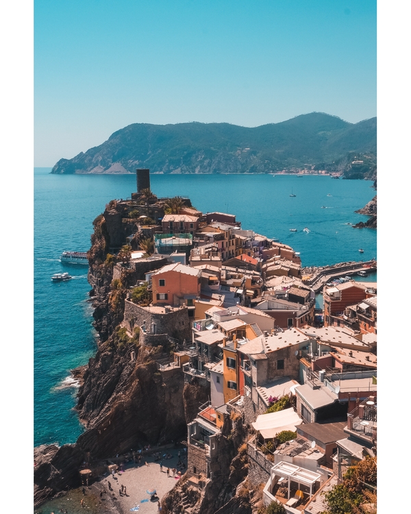 Coastal village on cliffs above turquoise sea