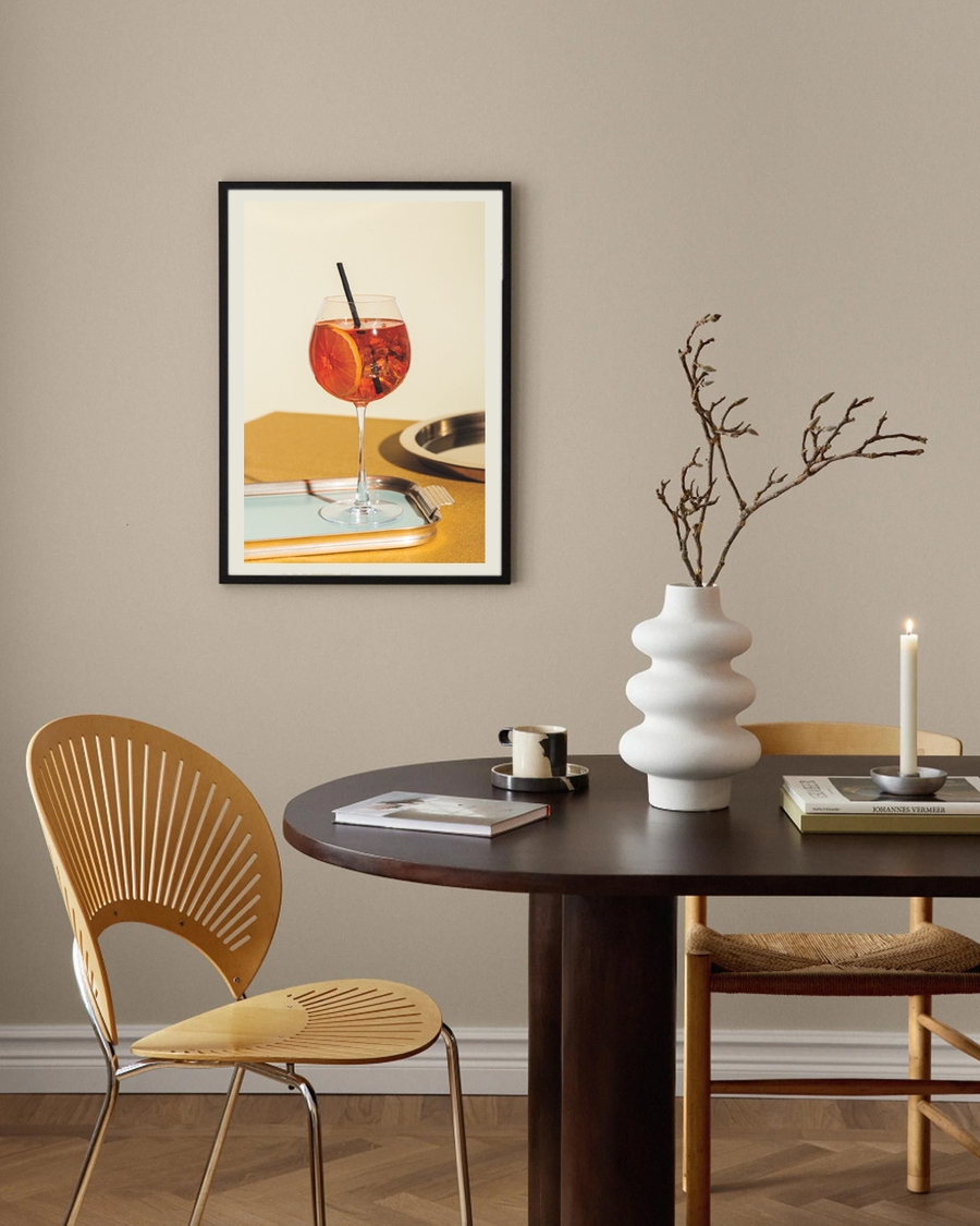 A poster of a Orange cocktail in wine glass on tray