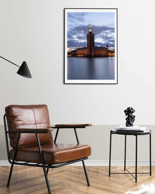 A poster of a Stockholm City Hall at twilight by waterfront